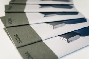 Close-up of folded Sigma brochures showcasing product images and design, ideal for marketing.